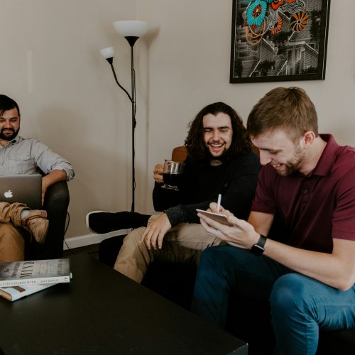 Three young men chatting in a living room Three young men chatting in a living room