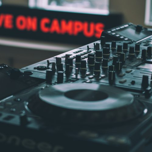Live on Campus sign behind DJ decks Live on Campus sign behind DJ decks