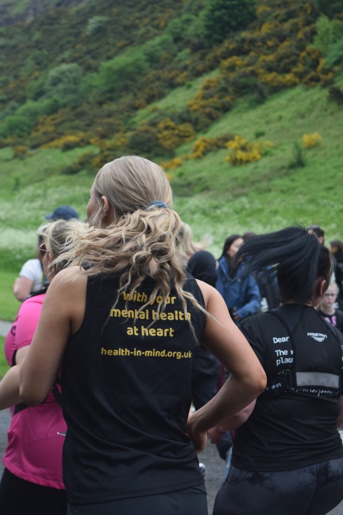 Runner in Health in Mind in crowd of people in front of Arthur's Seat Runner in Health in Mind in crowd of people in front of Arthur's Seat